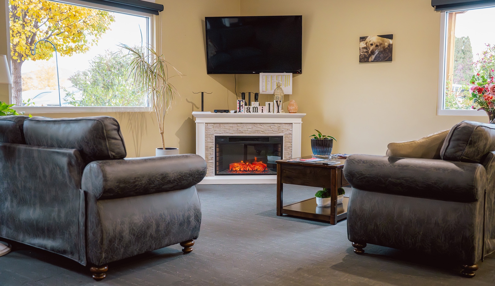 cozy sitting area with two chairs in front of a fireplace