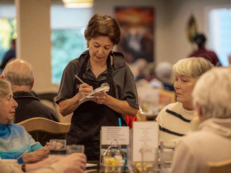 staff member taking dining orders from residents