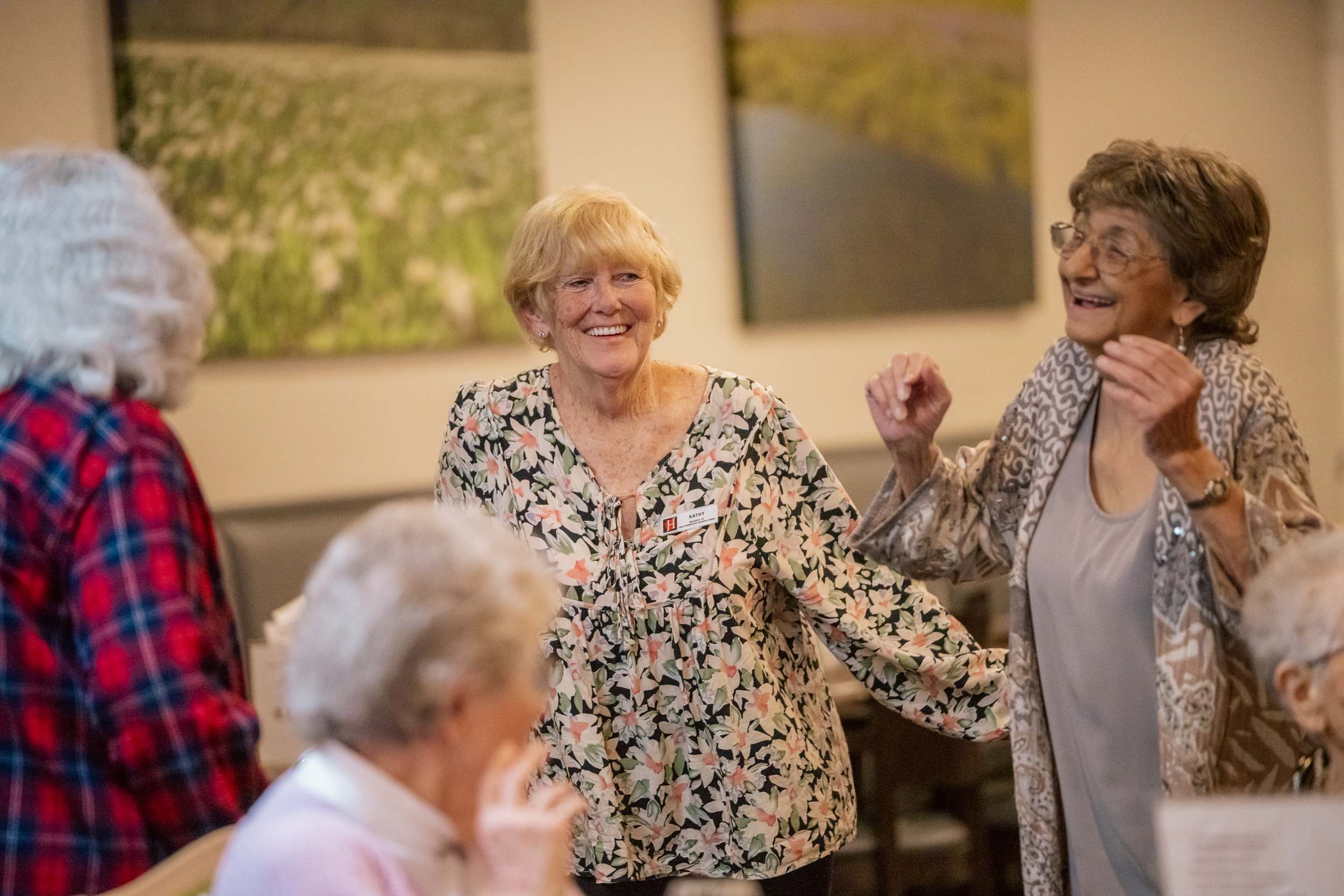 group of senior female friends chatting and smiling