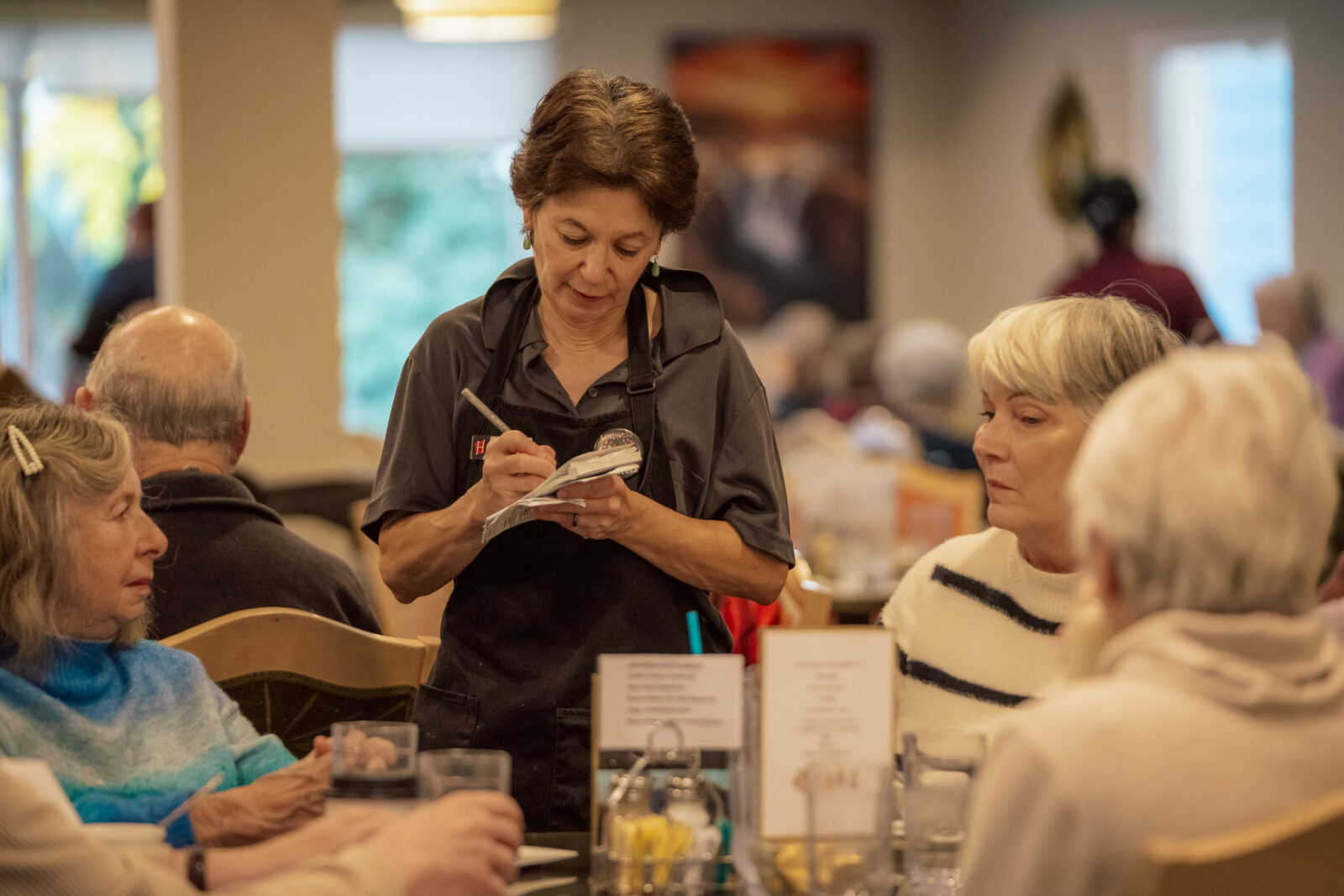 dining staff member taking resident's orders