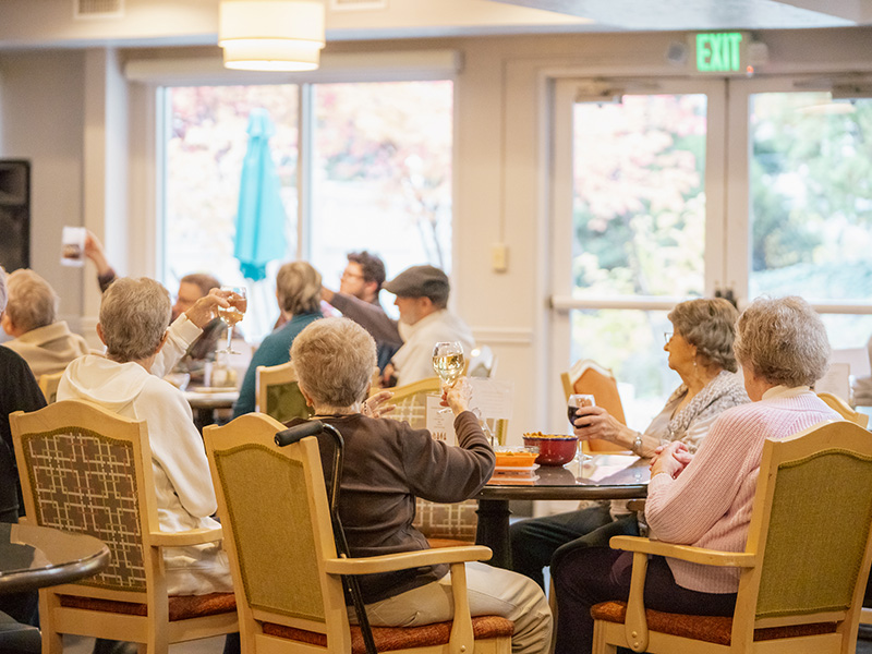 dining room full of residents making a toast