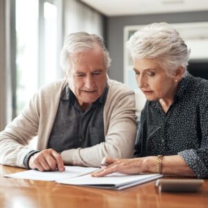 An older woman and man review information on senior living.